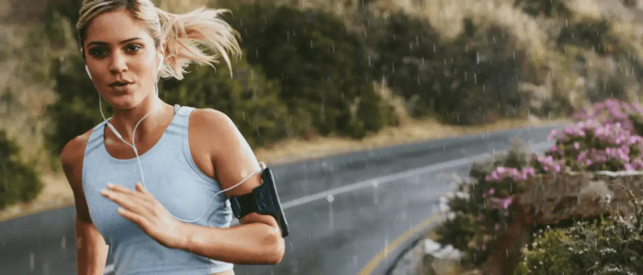 Female runner in an outdoor setting, focusing on endurance and recovery.