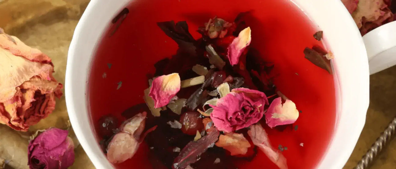Herbal adaptogenic tea blend in a cup with flowers.