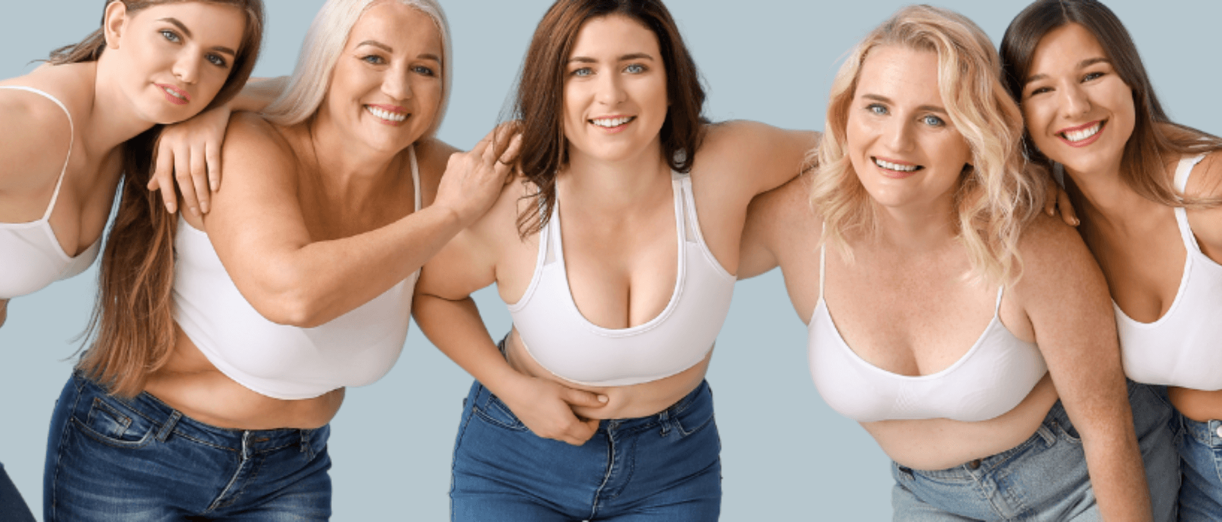 A diverse group of women smiling and embracing body positivity in a wellness-focused setting.