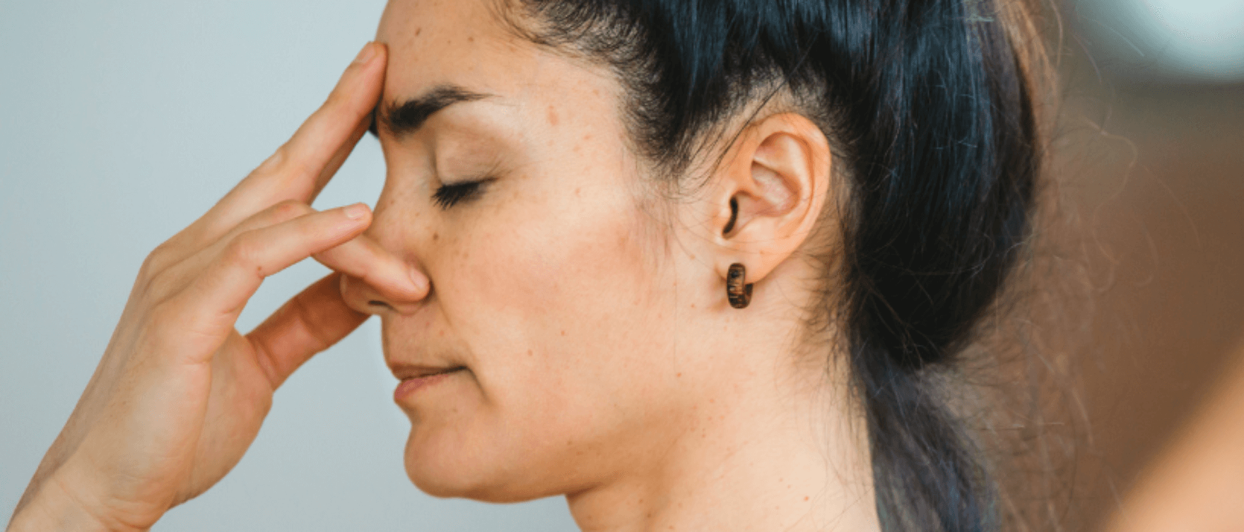 Close-up of a woman practicing focused breathing for vagal stimulation and better sleep.