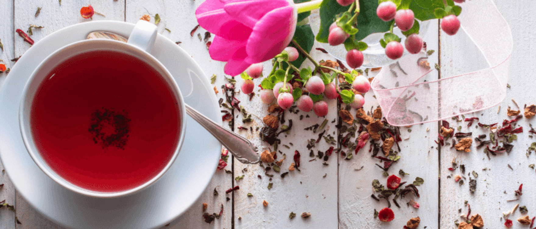 Tea setup with herbs and flowers, showcasing the benefits of tea for women’s hormones