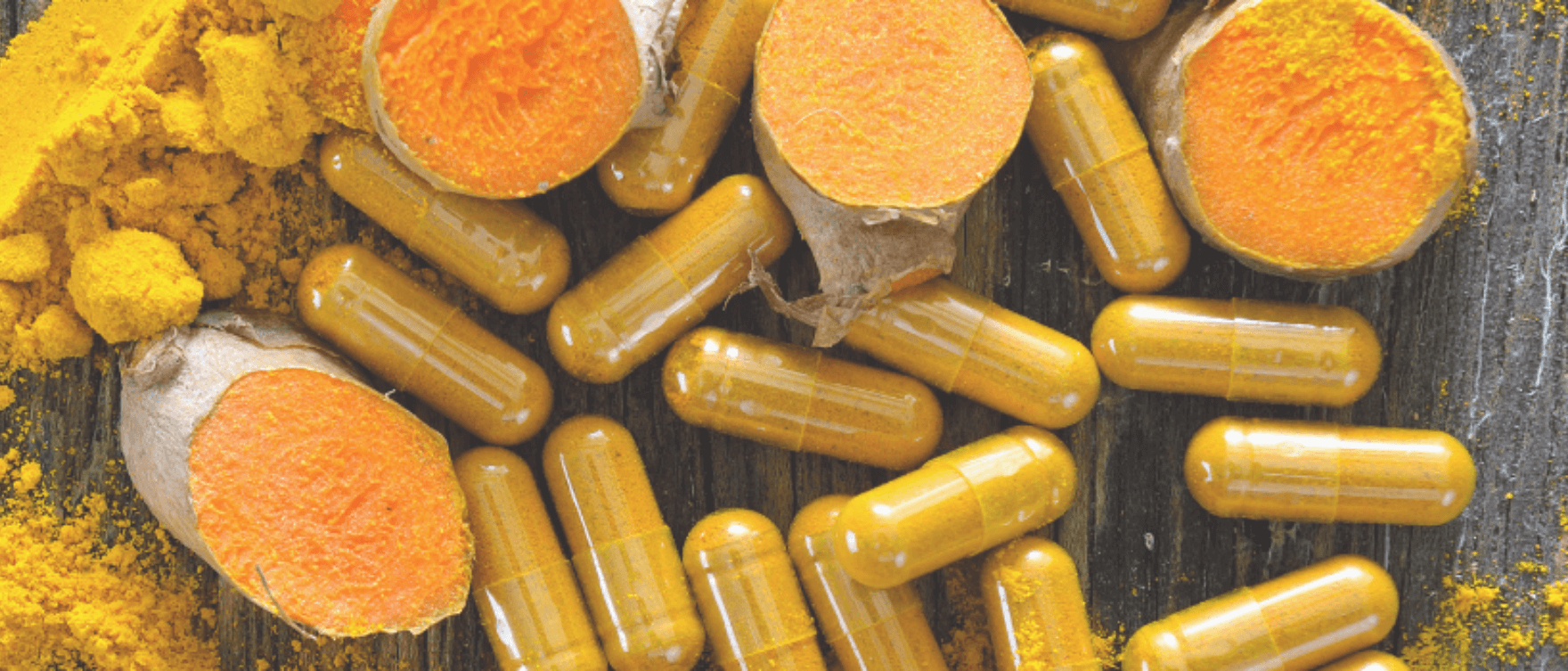 Capsules and turmeric roots showcasing natural anti-inflammatory properties for joint health and longevity.