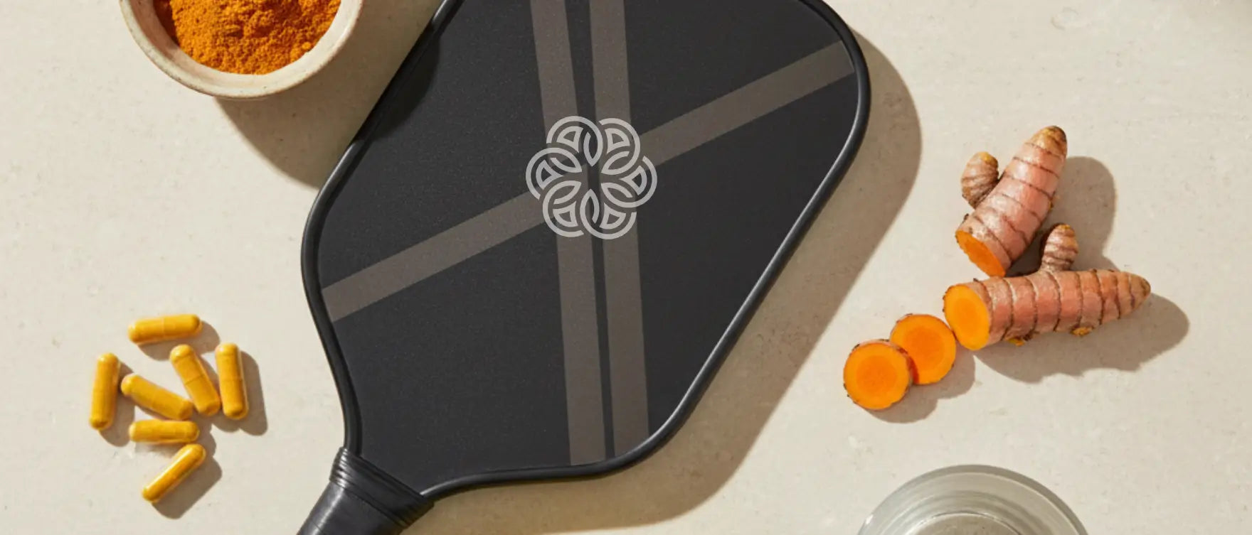 Turmeric for athletes shown with pickleball paddle and capsules as part of a joint pain supplement routine