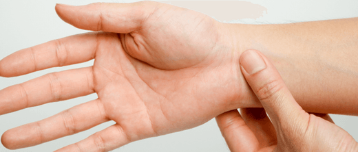 A person holding their hand showing joint discomfort, emphasizing the benefits of turmeric for joint health.