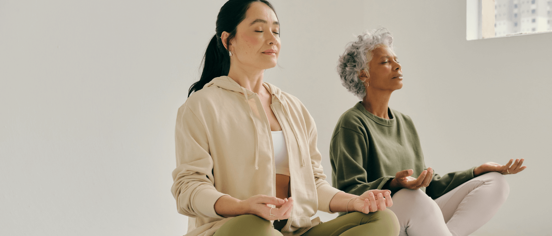 Two women practicing meditation - How Turmeric Enhances Women's Health Naturally.