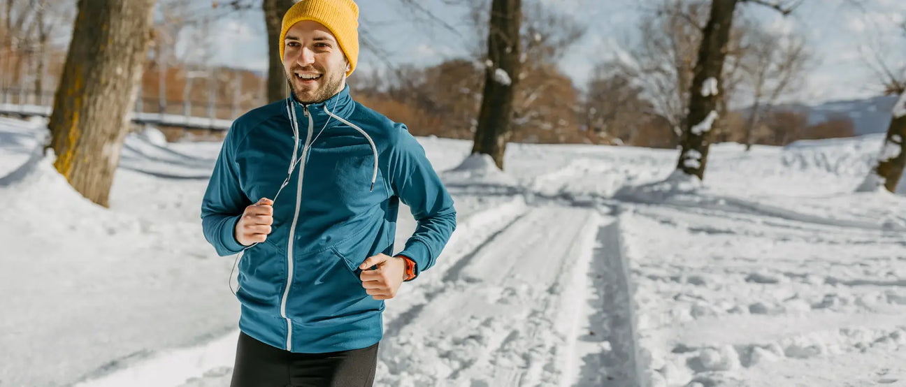 man jogging outdoors in winter snow to stay active and reduce inflammation naturally