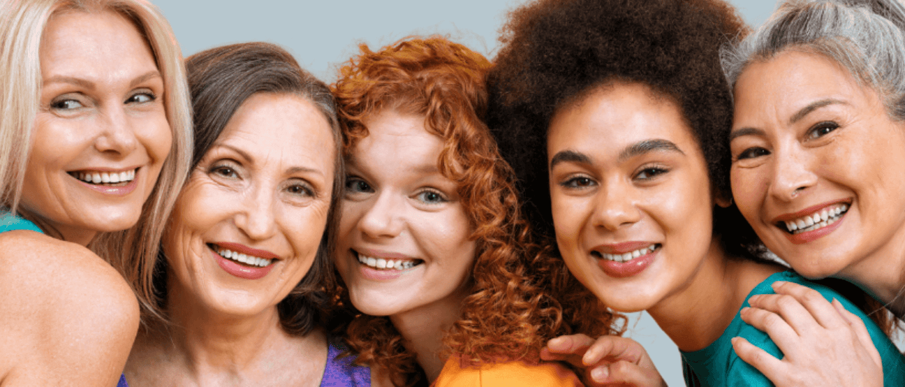 A diverse group of confident women smiling together, representing empowerment and unity.