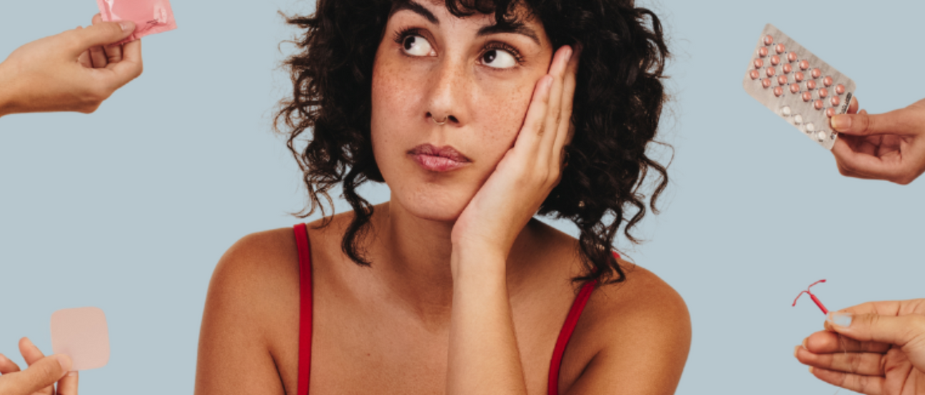 Confused woman surrounded by different birth control options, looking unsure about hormonal balance