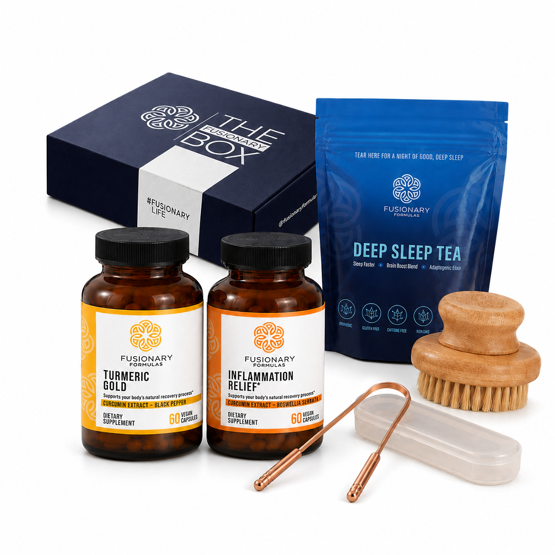 A Fusionary Life wellness gift set arranged on a white background, including a dark blue branded box, a blue pouch of deep sleep tea, two amber supplement bottles labeled Turmeric Gold and Inflammation Relief, a wooden scrubber, a copper cleansing tool, and a small white case.