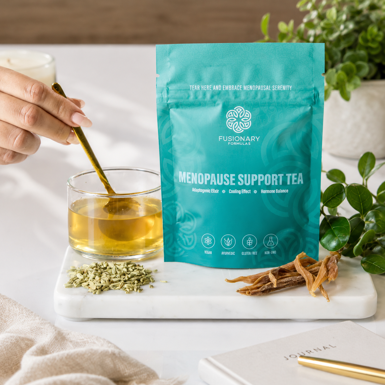 Menopause support tea package with a glass of tea and tea leaves on a marble board.