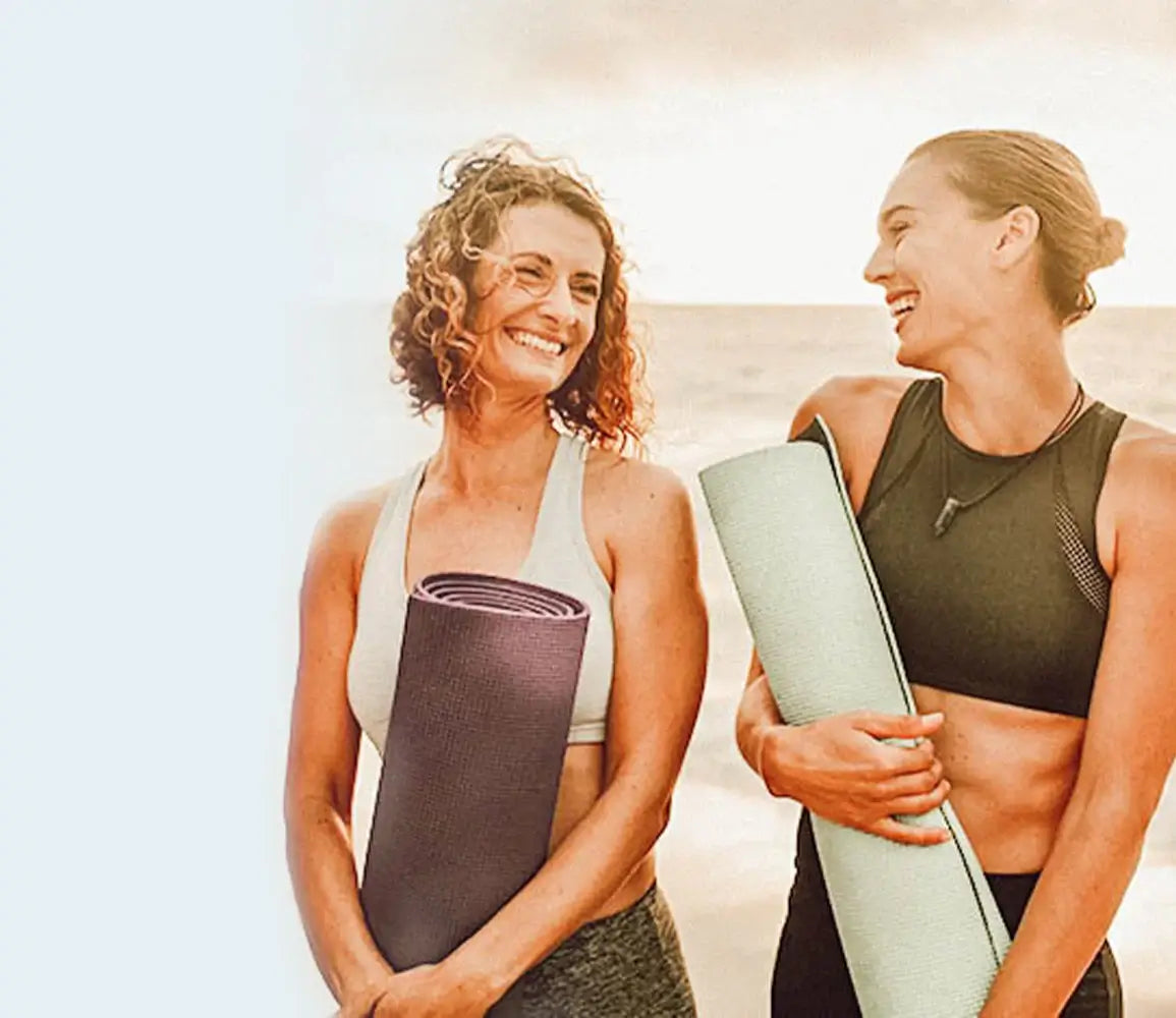 friends walking on beach after yoga class