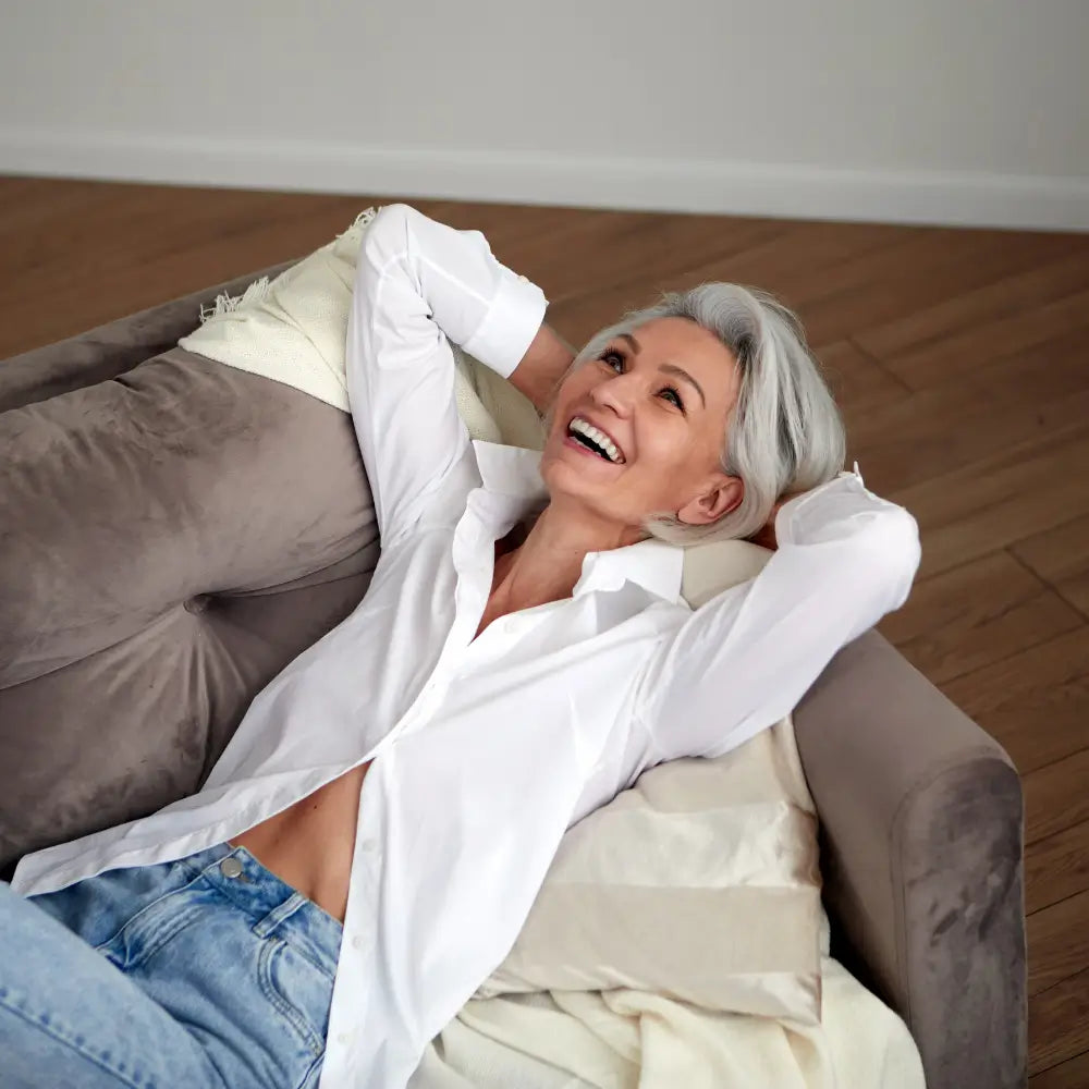 Woman laying on couch happy